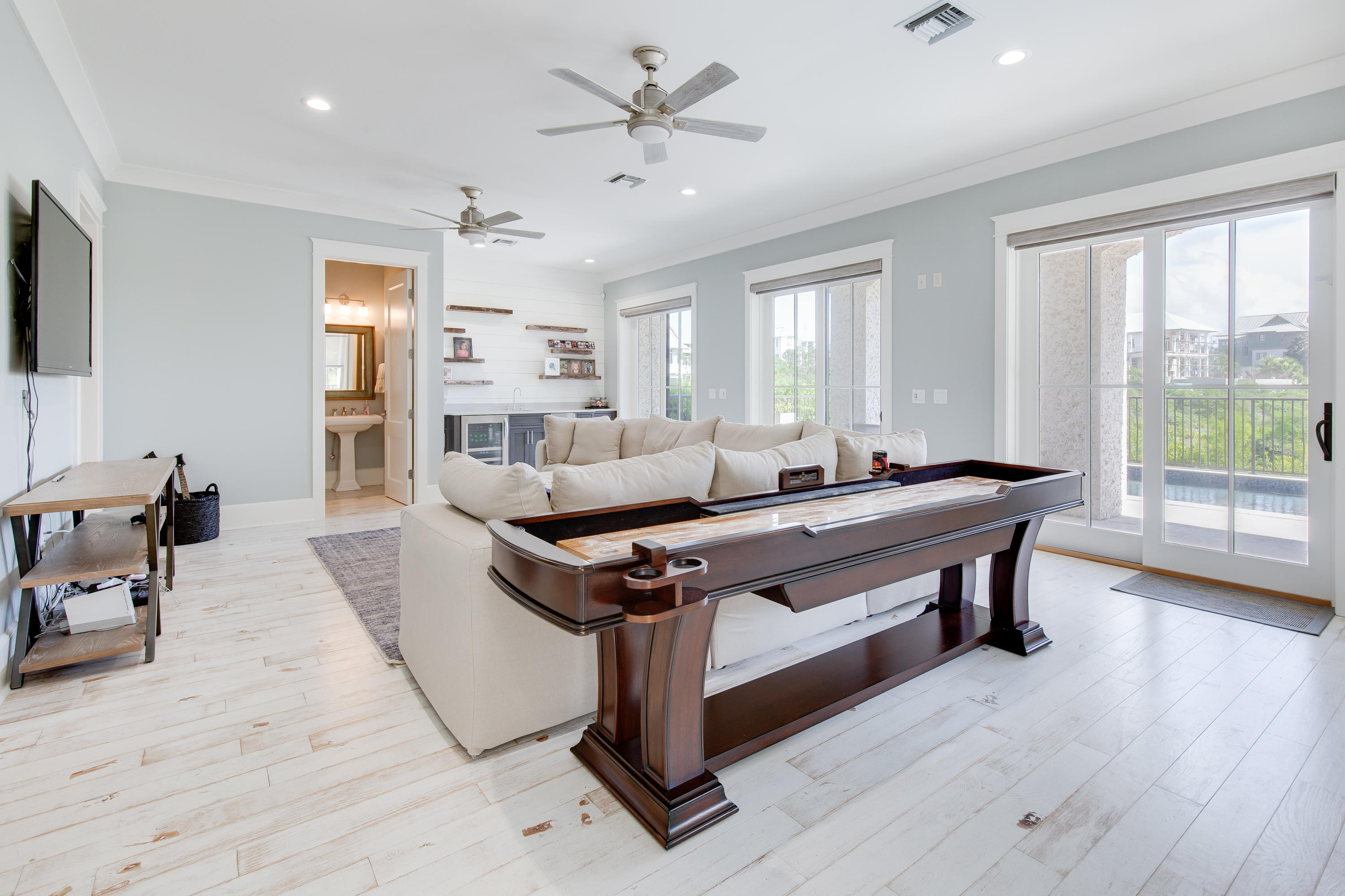 201 West Bermuda Drive Santa Rosa Beach, FL 32459 - Photo 22 of 56 a living room with furniture a wooden floor and a large window