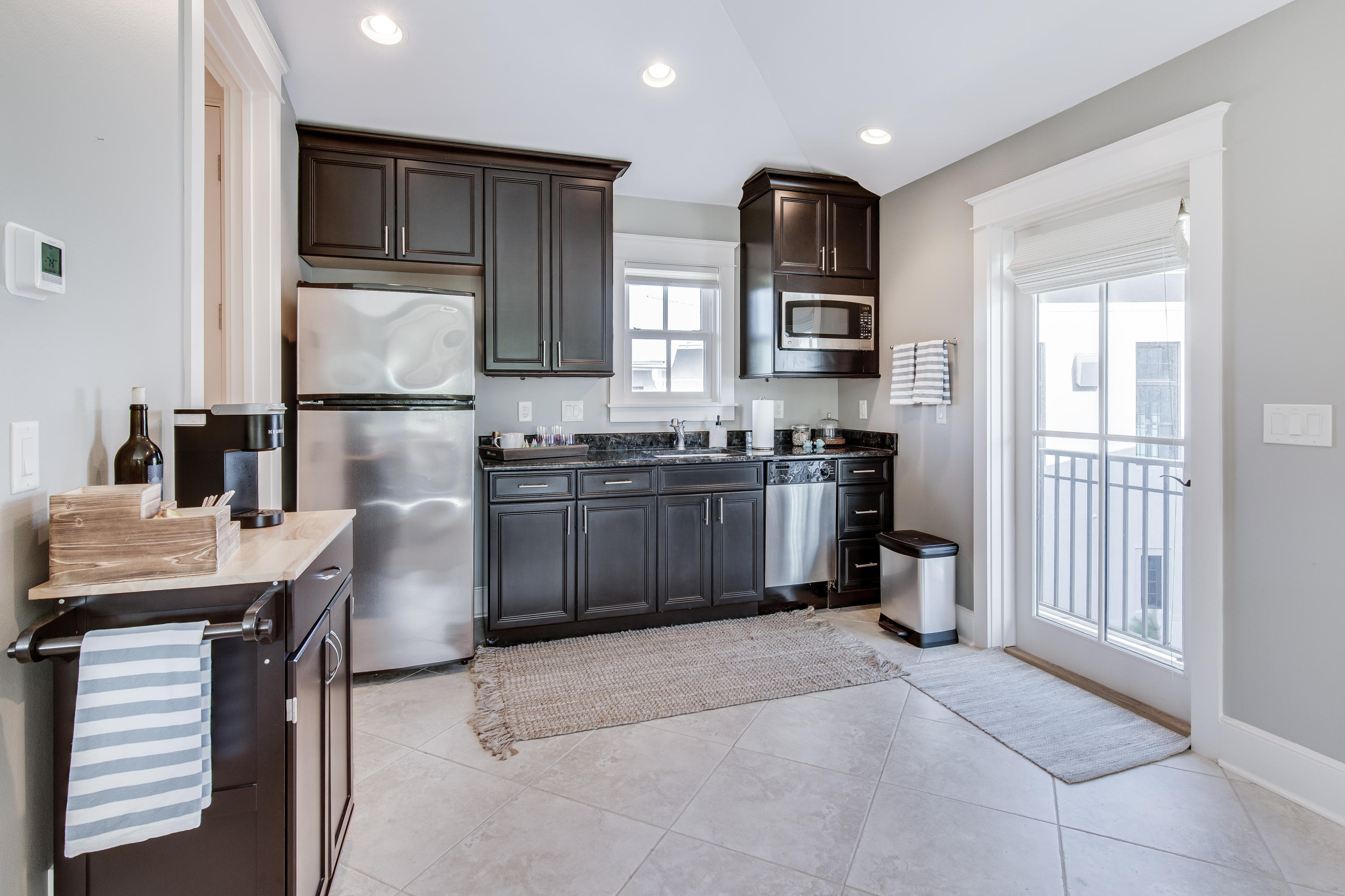 201 West Bermuda Drive Santa Rosa Beach, FL 32459 - Photo 33 of 56 a kitchen with stainless steel appliances granite countertop a stove top oven a sink a dining table and chairs