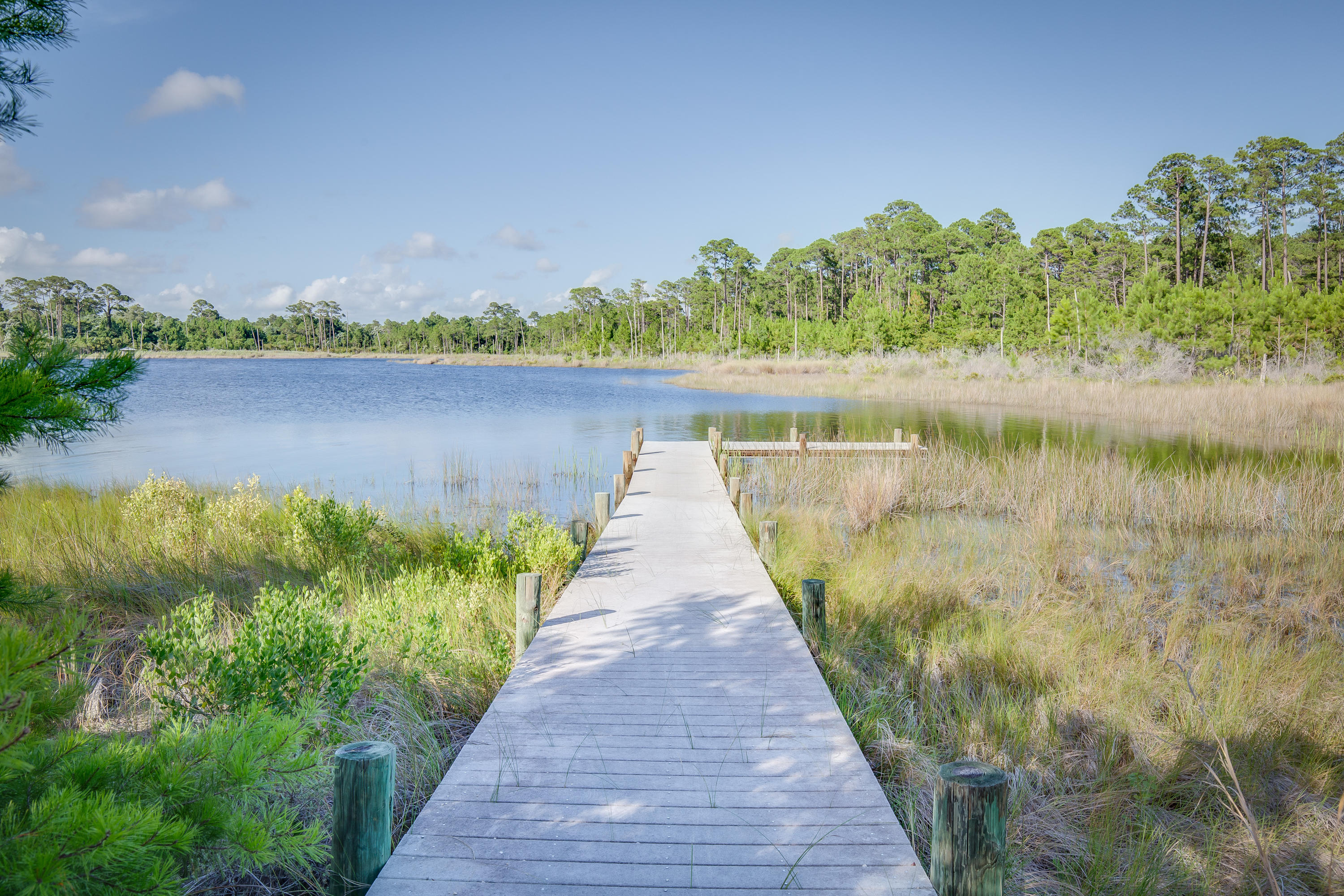 201 West Bermuda Drive Santa Rosa Beach, FL 32459 - Photo 46 of 56 a wooden pier with boats in a lake