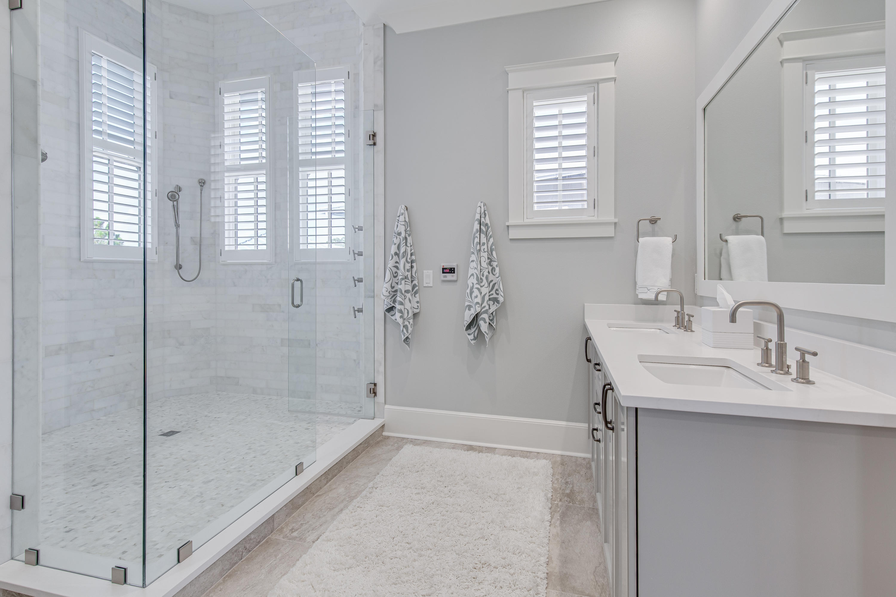 201 West Bermuda Drive Santa Rosa Beach, FL 32459 - Photo 10 of 56 a bathroom with a shower sink and mirror