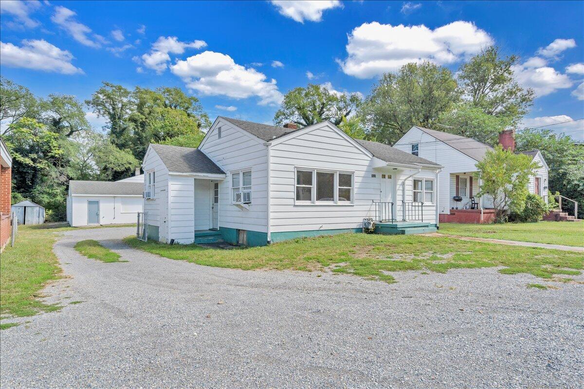 3121 Plantation Road Northeast Roanoke, VA 24012 - Photo 18 of 44 a front view of a house with a yard and garage