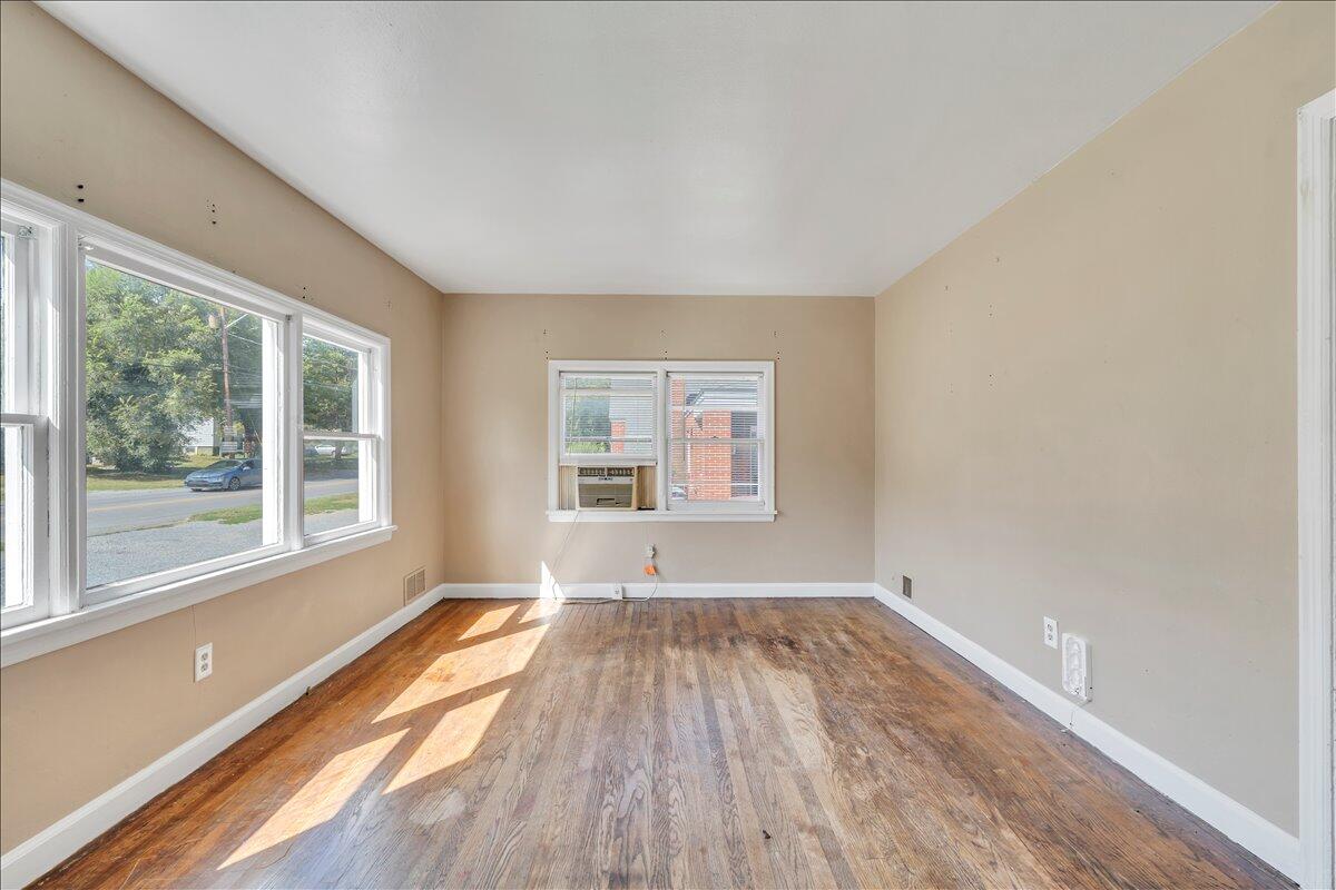 3121 Plantation Road Northeast Roanoke, VA 24012 - Photo 21 of 44 a view of an empty room with wooden floor and a window