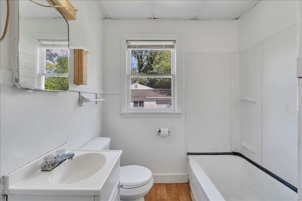 3121 Plantation Road Northeast Roanoke, VA 24012 - Photo 32 of 44 a bathroom with a sink a toilet and a window