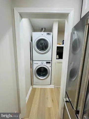 a large kitchen with stainless steel appliances a large counter top a stove and a refrigerator