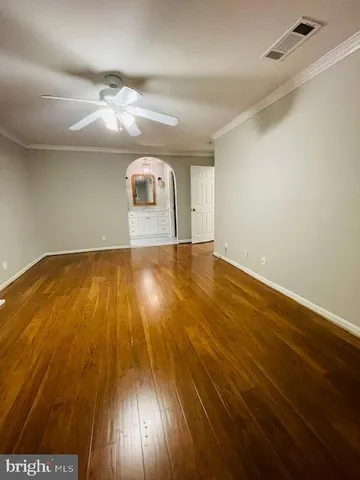 a view of a room with wooden floor
