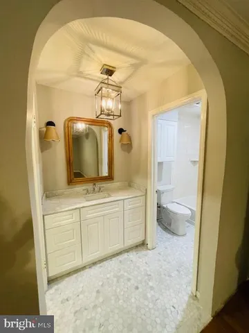 a view of a kitchen with wooden floor and a window