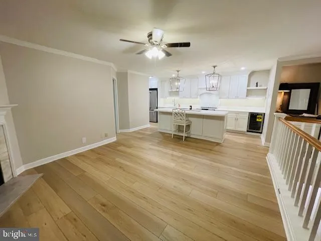 a view of an empty room with a fireplace and a window