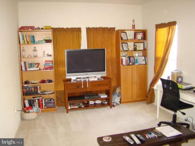 9204 Ribbon Falls Loop Bristow, VA 20136 - Photo 12 of 16 a living room with furniture and a flat screen tv