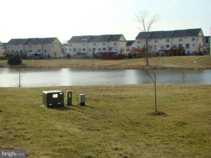 9204 Ribbon Falls Loop Bristow, VA 20136 - Photo 16 of 16 a view of a lake with a mountain