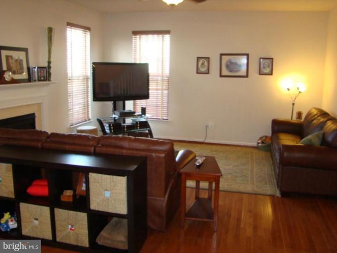 9204 Ribbon Falls Loop Bristow, VA 20136 - Photo 4 of 16 a living room with furniture and a flat screen tv