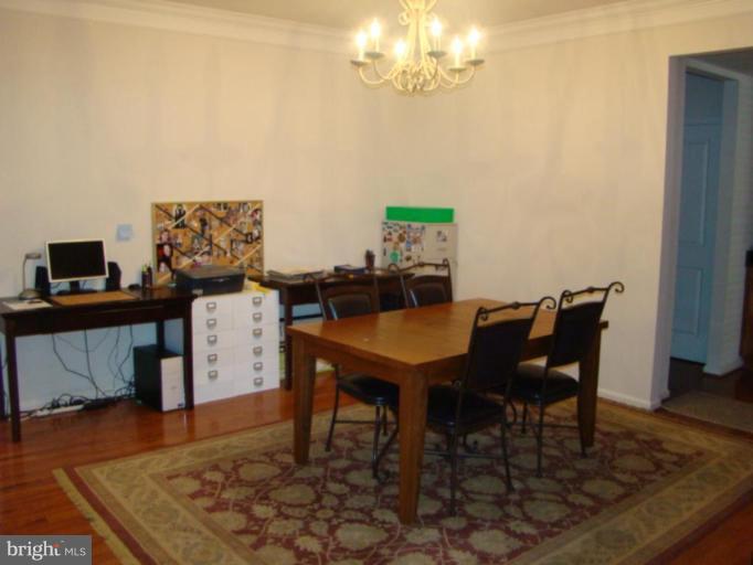 9204 Ribbon Falls Loop Bristow, VA 20136 - Photo 5 of 16 a view of a dining room with furniture and wooden floor