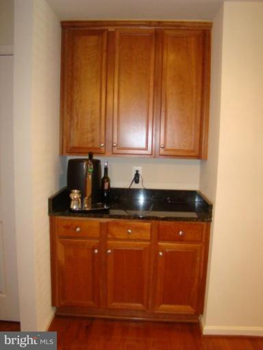 9204 Ribbon Falls Loop Bristow, VA 20136 - Photo 6 of 16 a view of a kitchen with wooden floor