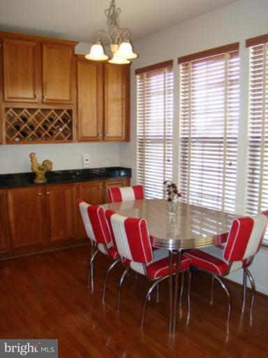 9204 Ribbon Falls Loop Bristow, VA 20136 - Photo 7 of 16 a view of a dining room with furniture and window