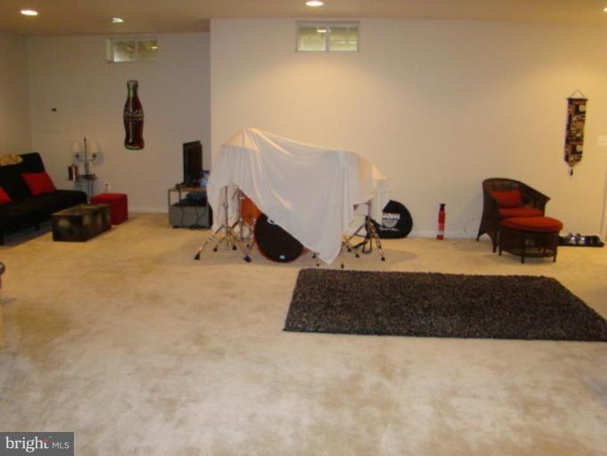 9204 Ribbon Falls Loop Bristow, VA 20136 - Photo 10 of 16 a bed room with a bed and a couch