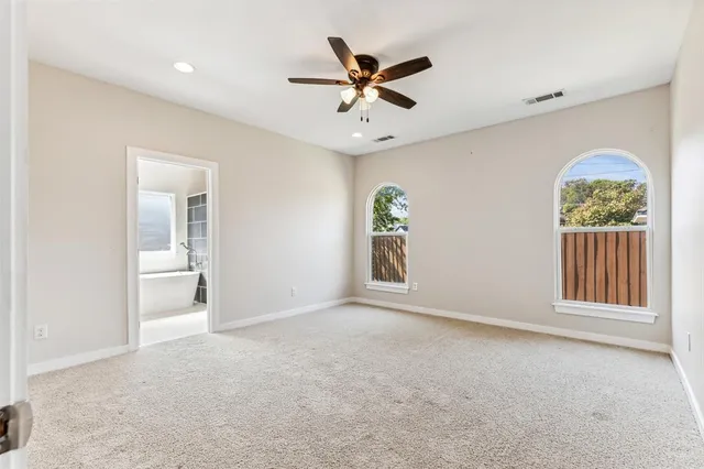 a bathroom with a granite countertop sink and a bathtub