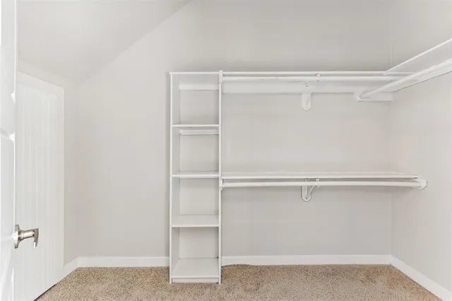 a view of a livingroom with a ceiling fan and window