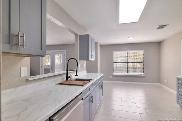 a kitchen with a sink and a window