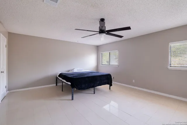 a room with a window and a ceiling fan