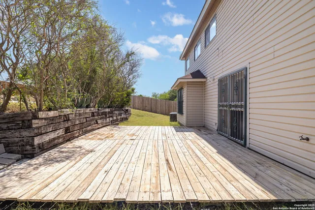 a view of backyard with a deck