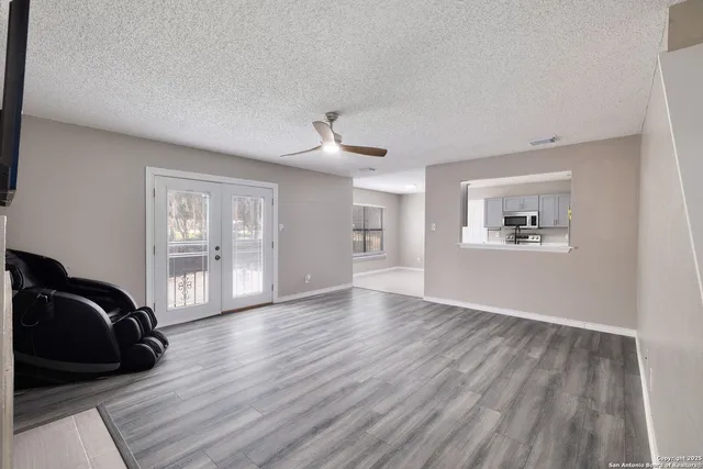 a view of a livingroom with wooden floor and furniture
