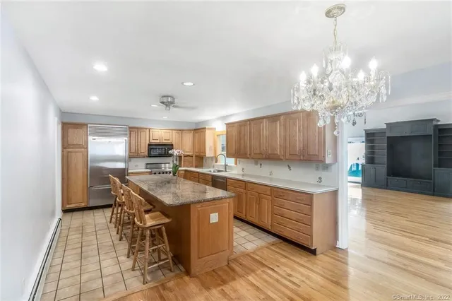 a kitchen with stainless steel appliances granite countertop a sink counter space and cabinets