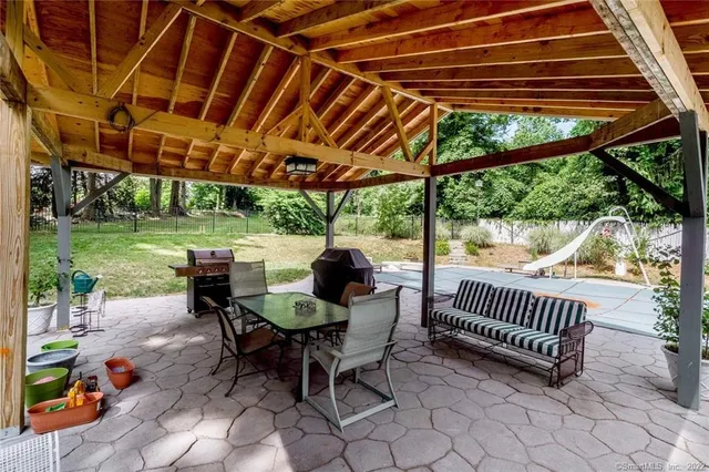 a view of a patio with a table chairs and a backyard