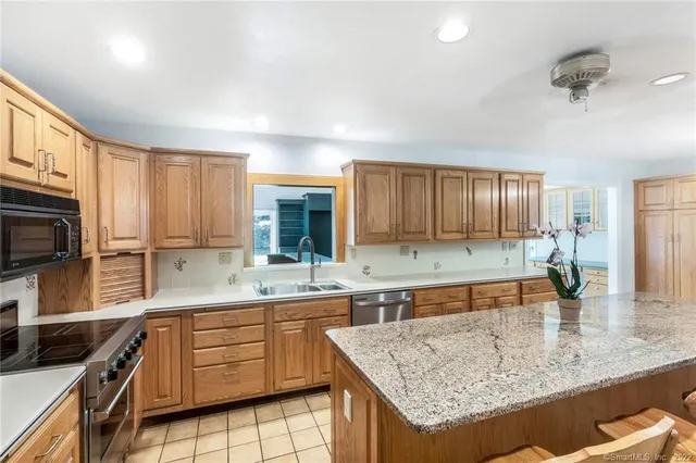 a kitchen with a sink stove and refrigerator