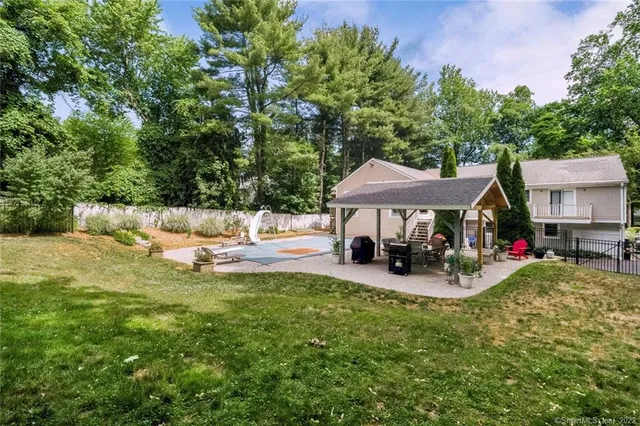 a view of a house with backyard porch and sitting area
