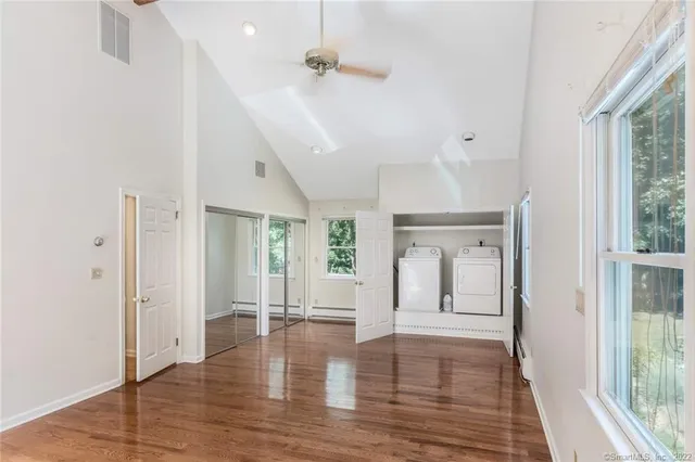 wooden floor in an empty room with a window