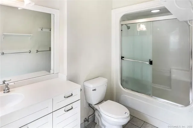 a white toilet sitting next to a bathroom sink