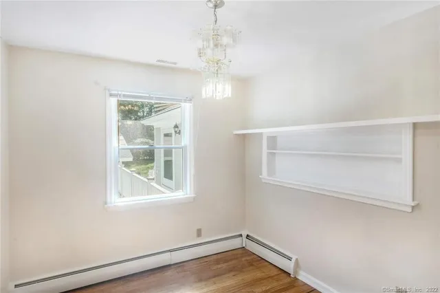 a view of a room with wooden floor and windows