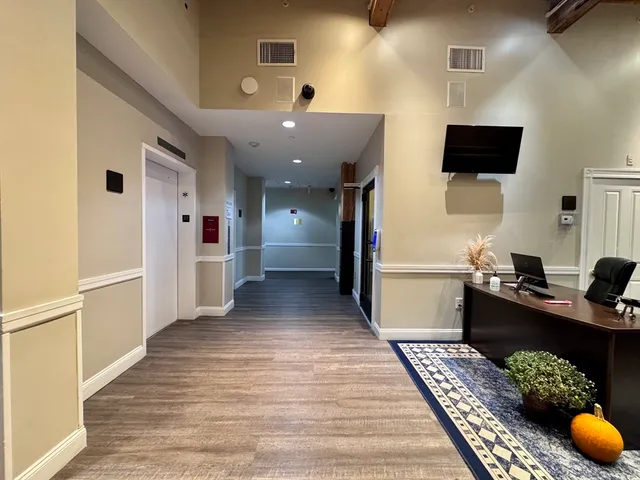 a kitchen with stainless steel appliances kitchen island granite countertop a refrigerator and a stove top oven