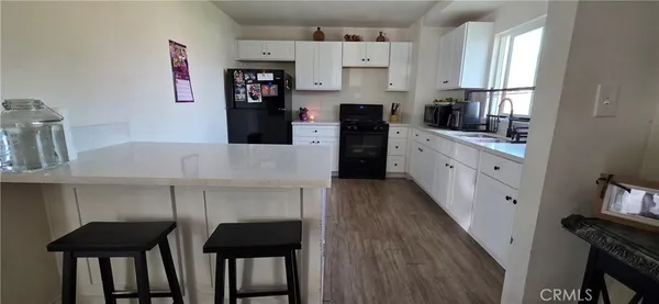 a kitchen with stainless steel appliances a stove refrigerator and cabinets