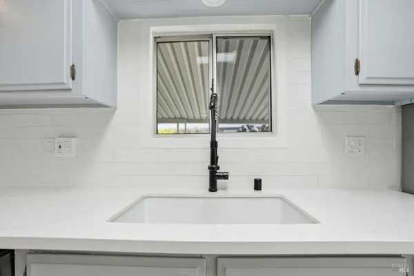 a bathroom with a bathtub and a window