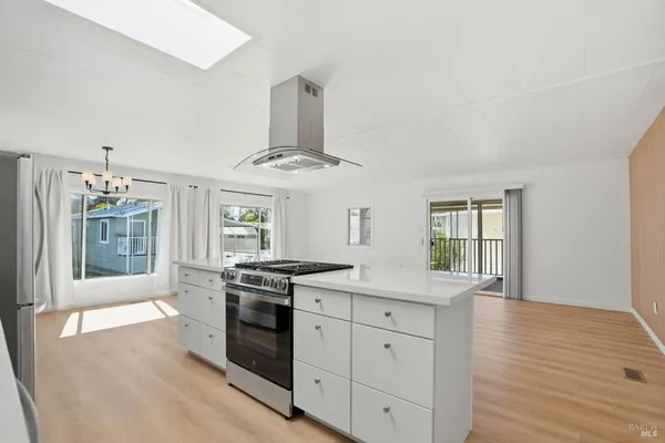 a kitchen with stainless steel appliances granite countertop a stove and a sink