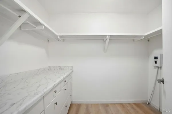 a spacious bathroom with a double vanity sink a mirror and a shower