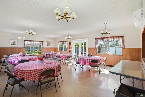 a kitchen with a stove a sink dishwasher and a refrigerator with wooden cabinets