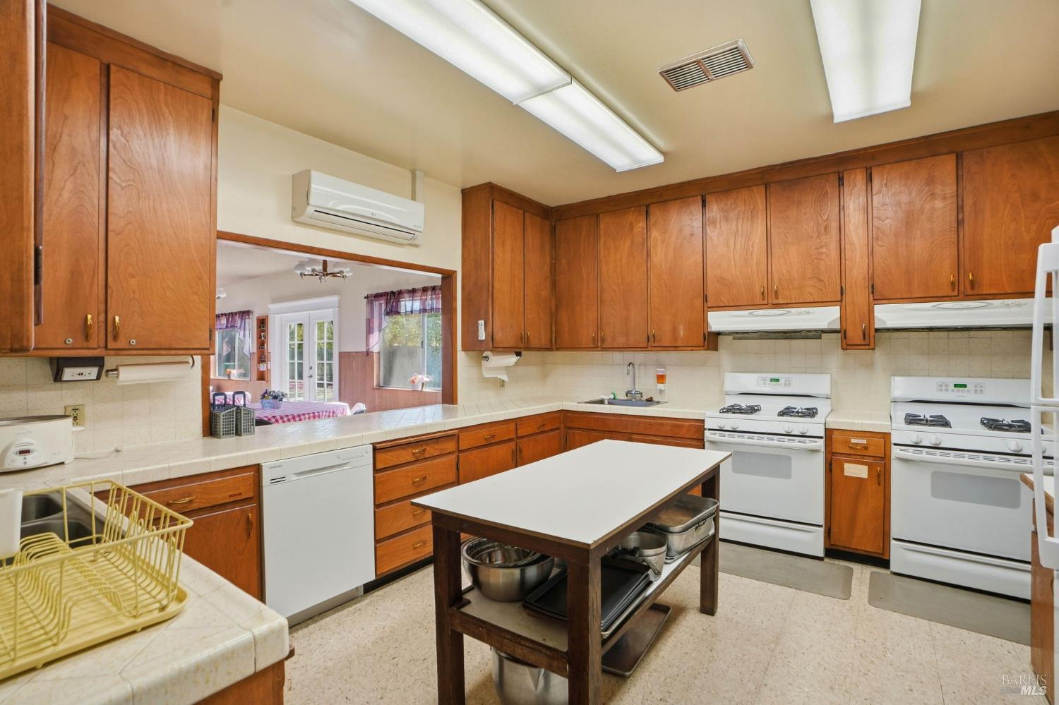 59 Colonial Park Drive Santa Rosa, CA 95403 - Photo 32 of 35 a kitchen with a stove a sink dishwasher and a refrigerator with wooden cabinets
