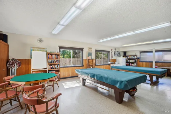 a view of swimming pool with outdoor seating and yard in back