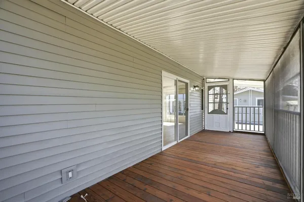 a view of a porch with wooden floor