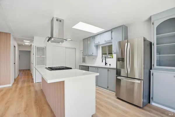 a kitchen with a refrigerator a sink and a stove