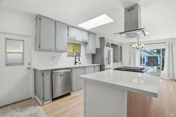 a kitchen with stainless steel appliances a sink stove and refrigerator
