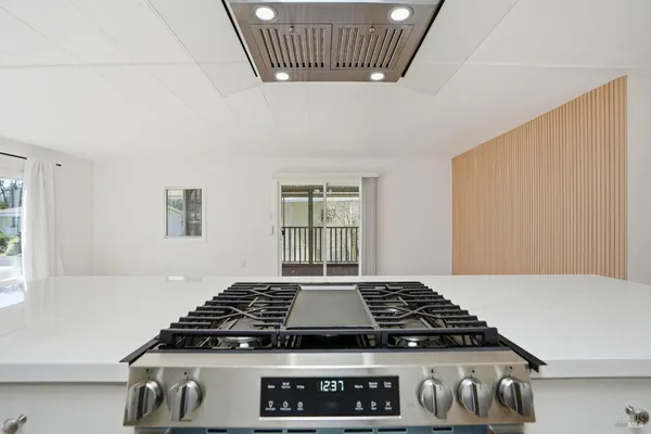 a stove top oven sitting inside of a kitchen