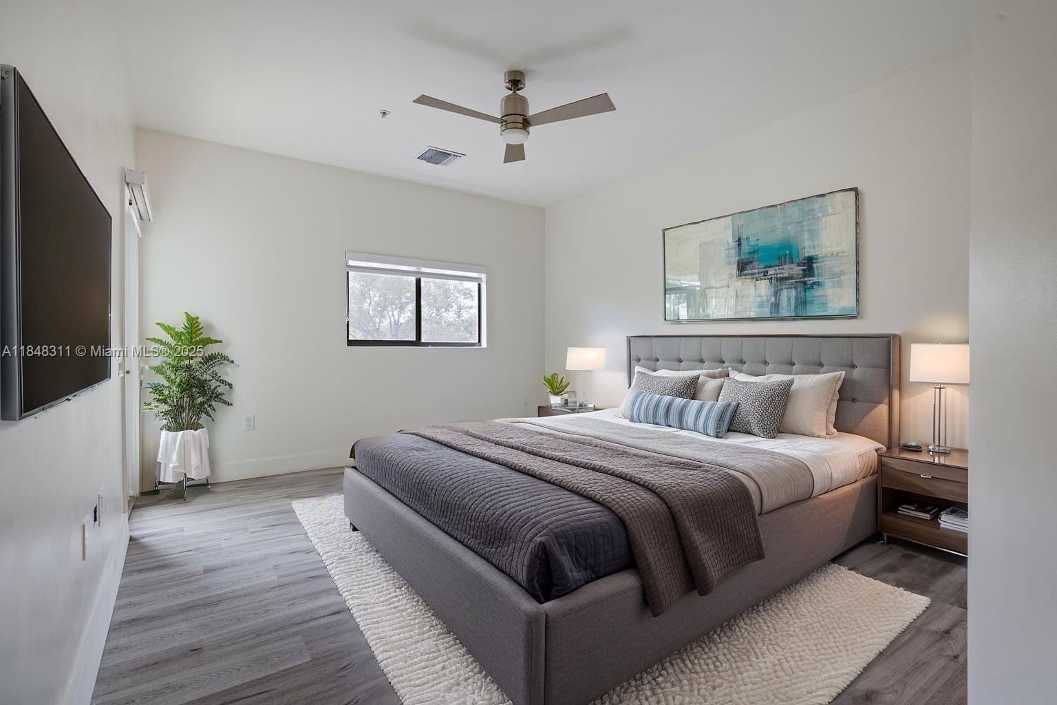 891 Northwest 45th Terrace Plantation, FL 33317 - Photo 11 of 33 a bedroom with a large bed and a flat screen tv