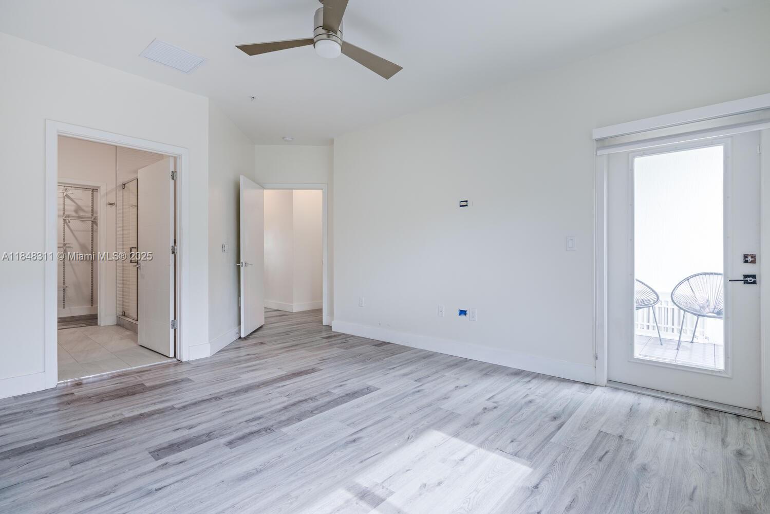 891 Northwest 45th Terrace Plantation, FL 33317 - Photo 13 of 33 an empty room with wooden floor and windows