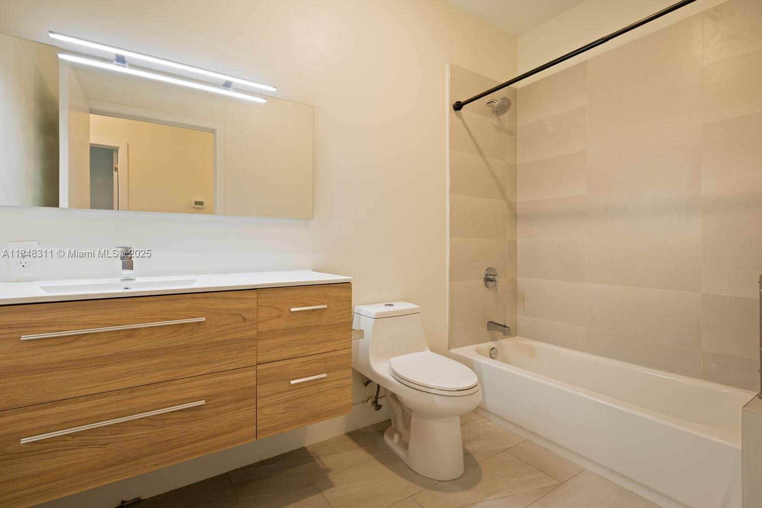 891 Northwest 45th Terrace Plantation, FL 33317 - Photo 18 of 33 a bathroom with a sink a toilet and shower