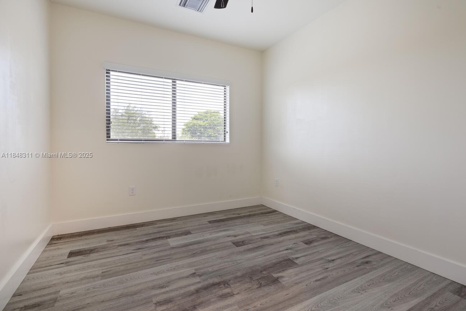 891 Northwest 45th Terrace Plantation, FL 33317 - Photo 19 of 33 wooden floor in an empty room with a window