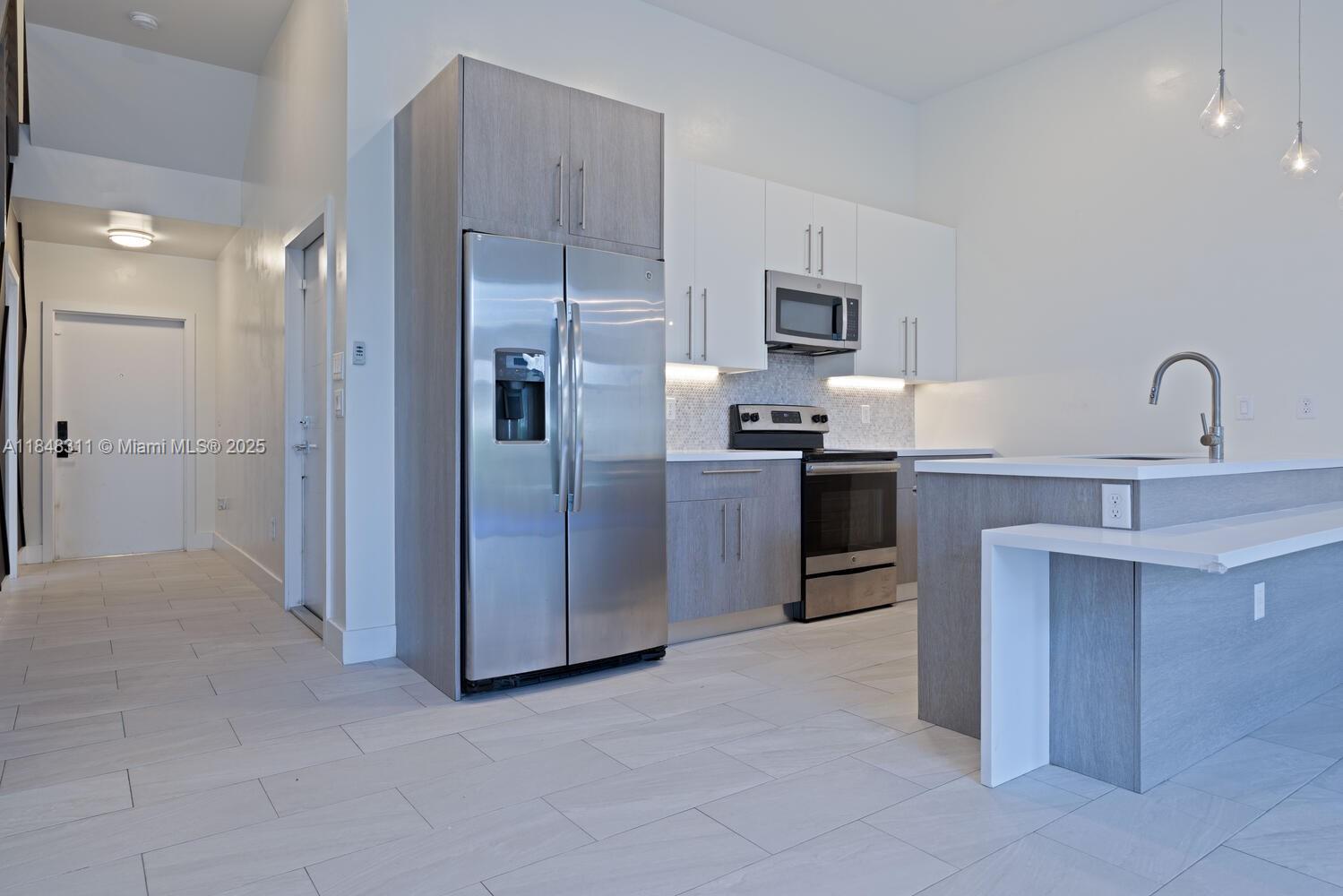 891 Northwest 45th Terrace Plantation, FL 33317 - Photo 2 of 33 a kitchen with stainless steel appliances granite countertop a refrigerator and a sink