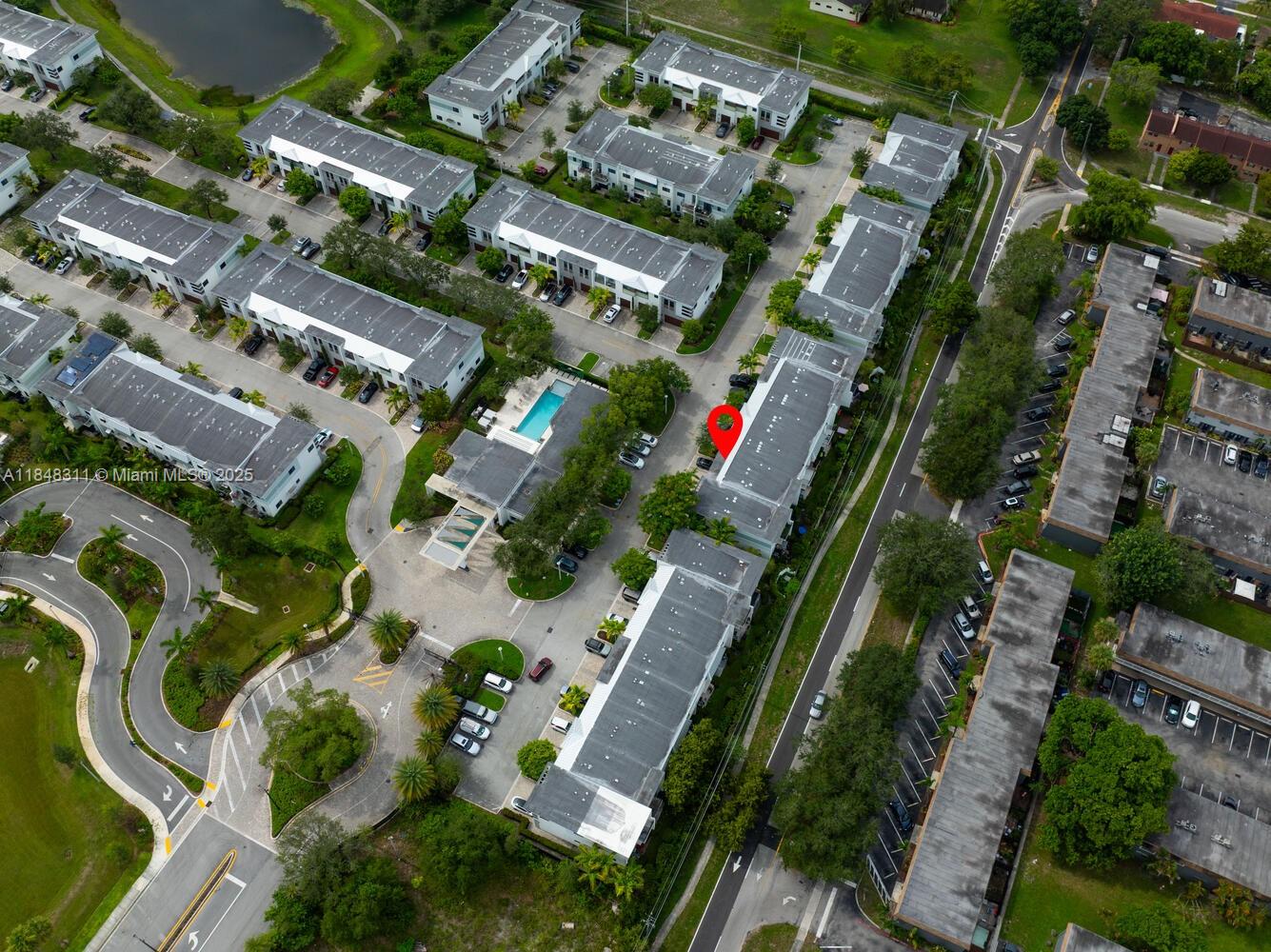 891 Northwest 45th Terrace Plantation, FL 33317 - Photo 30 of 33 an aerial view of a residential apartment building with a yard and parking spaces