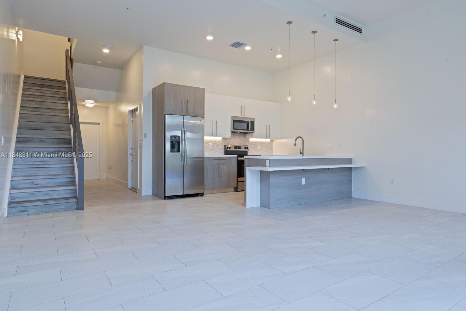 891 Northwest 45th Terrace Plantation, FL 33317 - Photo 3 of 33 a view of kitchen and refrigerator in a kitchen